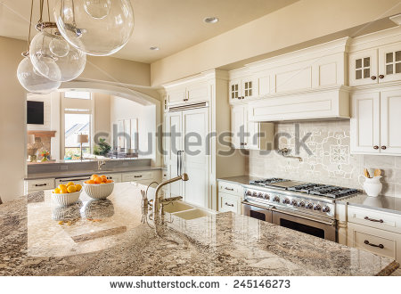 stock-photo-beautiful-new-kitchen-with-island-sink-cabinets-and-pendant-lights-in-new-home-245146273